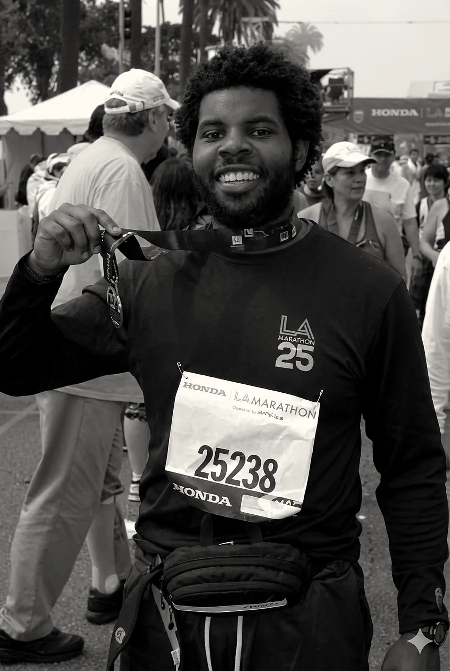 Matthew Scott holding his finisher medal at the 2010 LA Marathon